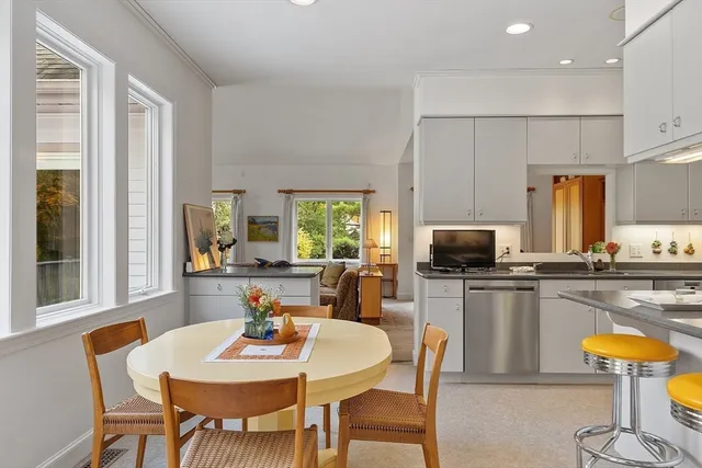 a view of a dining room with furniture and a kitchen