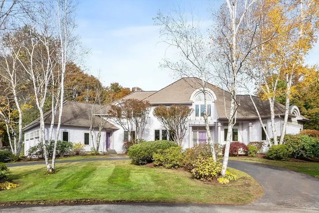 a front view of a residential houses with yard