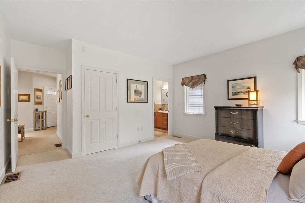 4 Hazelwood Circle Andover, MA 01810 - Photo 24 of 42 a bedroom with a bed and a chandelier