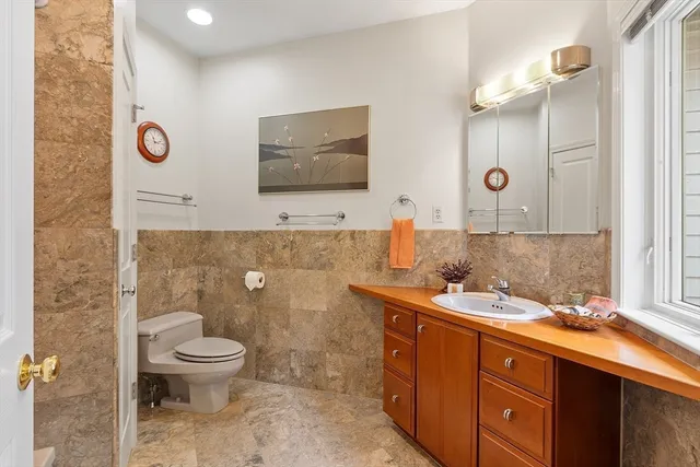 a bathroom with a toilet sink and mirror