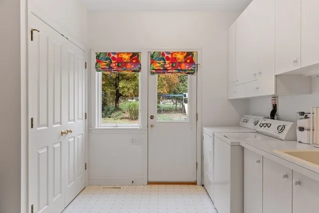 a utility room with cabinets dryer and washer