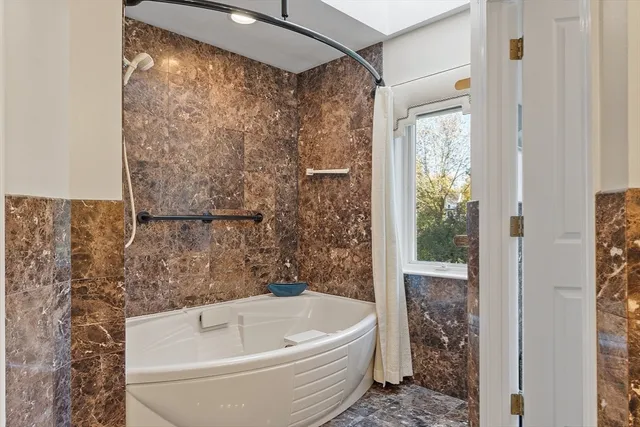 a bathroom with a bathtub and shower