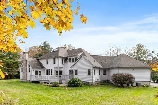 a front view of a house with a garden and swimming pool