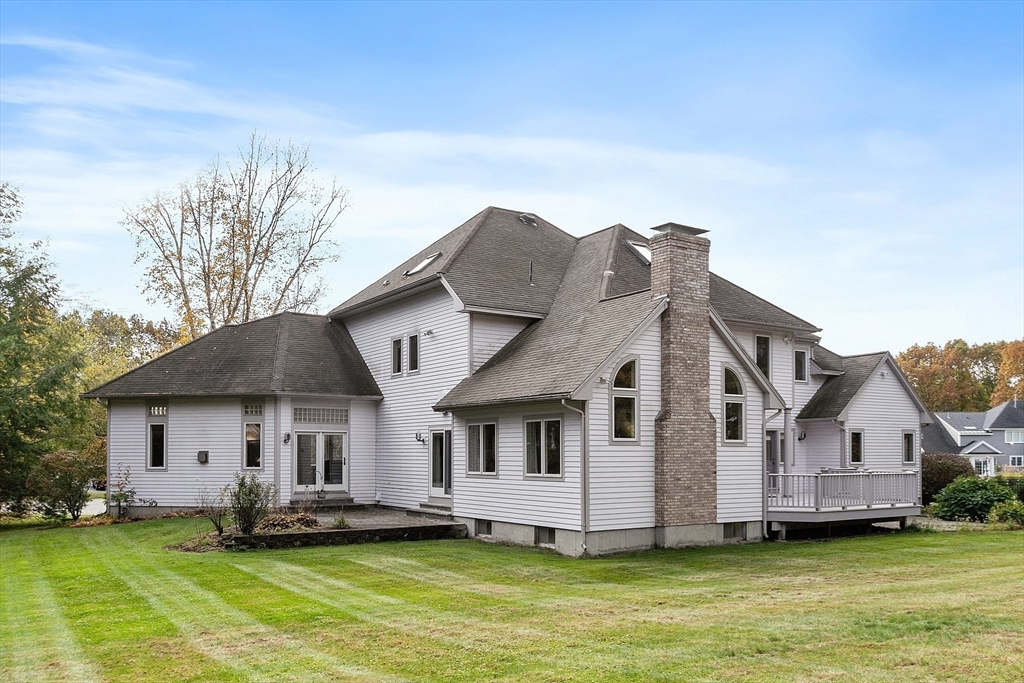 4 Hazelwood Circle Andover, MA 01810 - Photo 5 of 42 a front view of a house with a yard