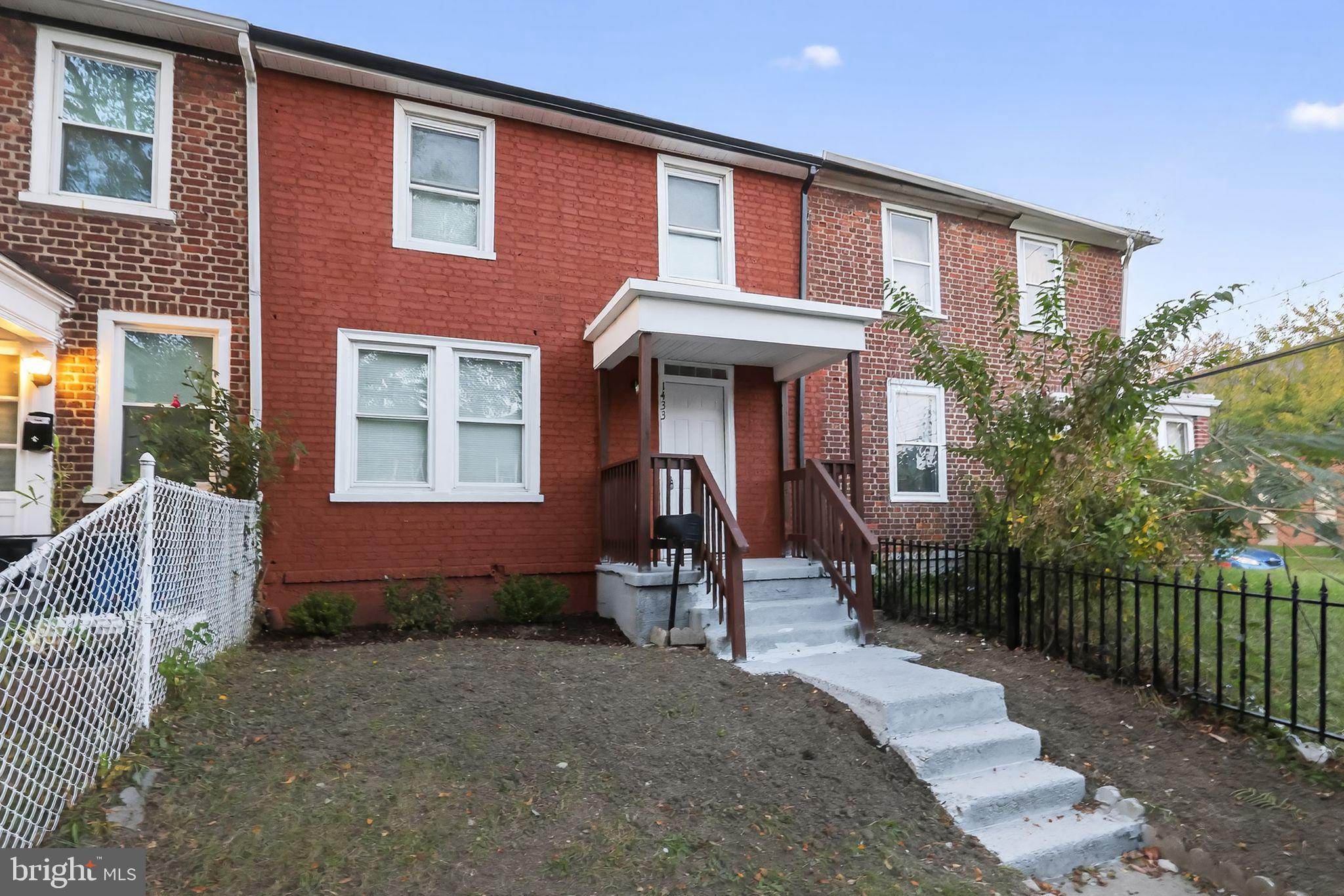 a front view of a house with a garden and balcony