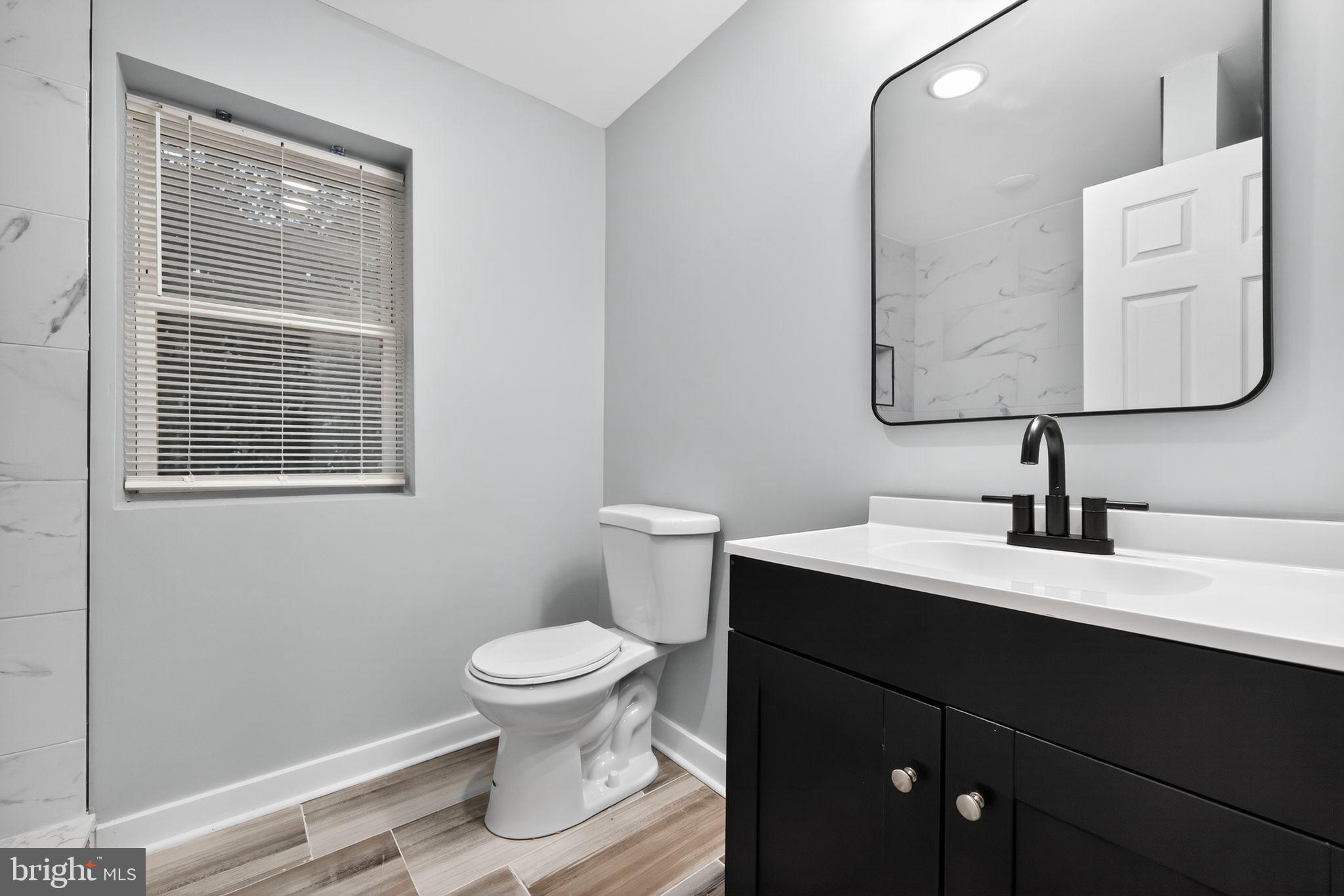 1433 North Chesapeake Road Camden, NJ 08104 - Photo 13 of 15 a bathroom with a toilet sink and mirror