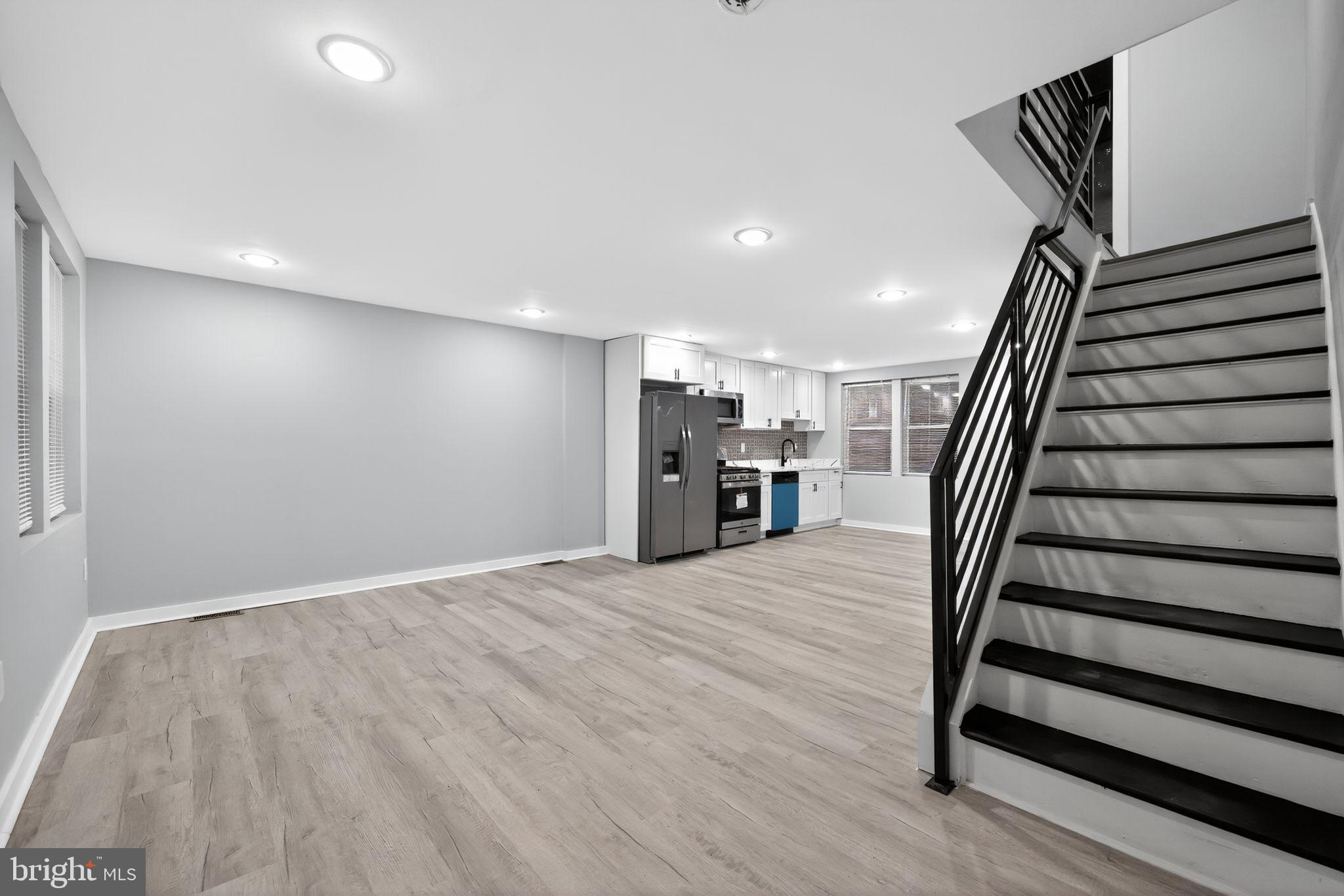1433 North Chesapeake Road Camden, NJ 08104 - Photo 4 of 15 a view of a livingroom with wooden floor and stairs