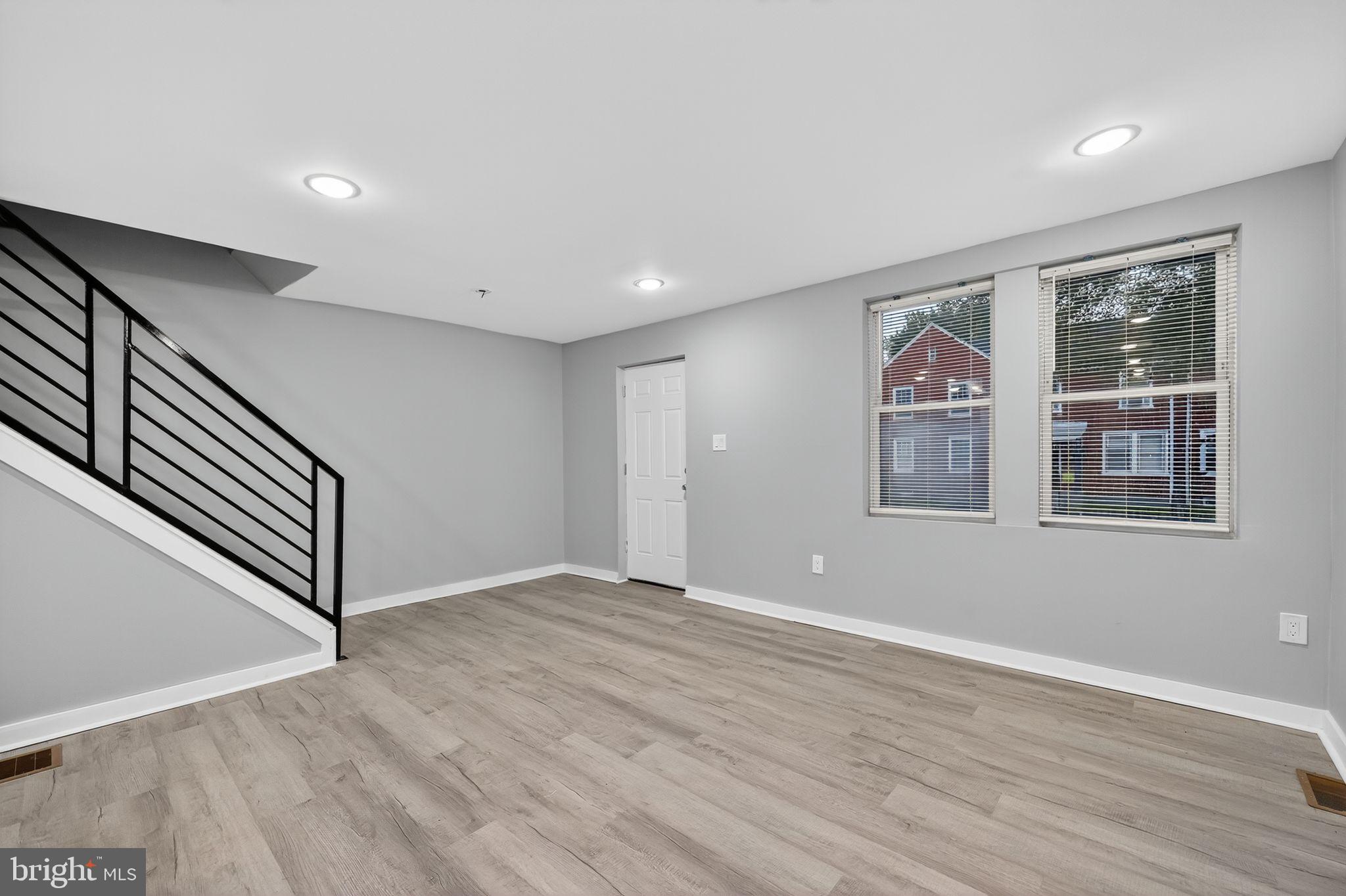 1433 North Chesapeake Road Camden, NJ 08104 - Photo 6 of 15 a view of an empty room with wooden floor and a window