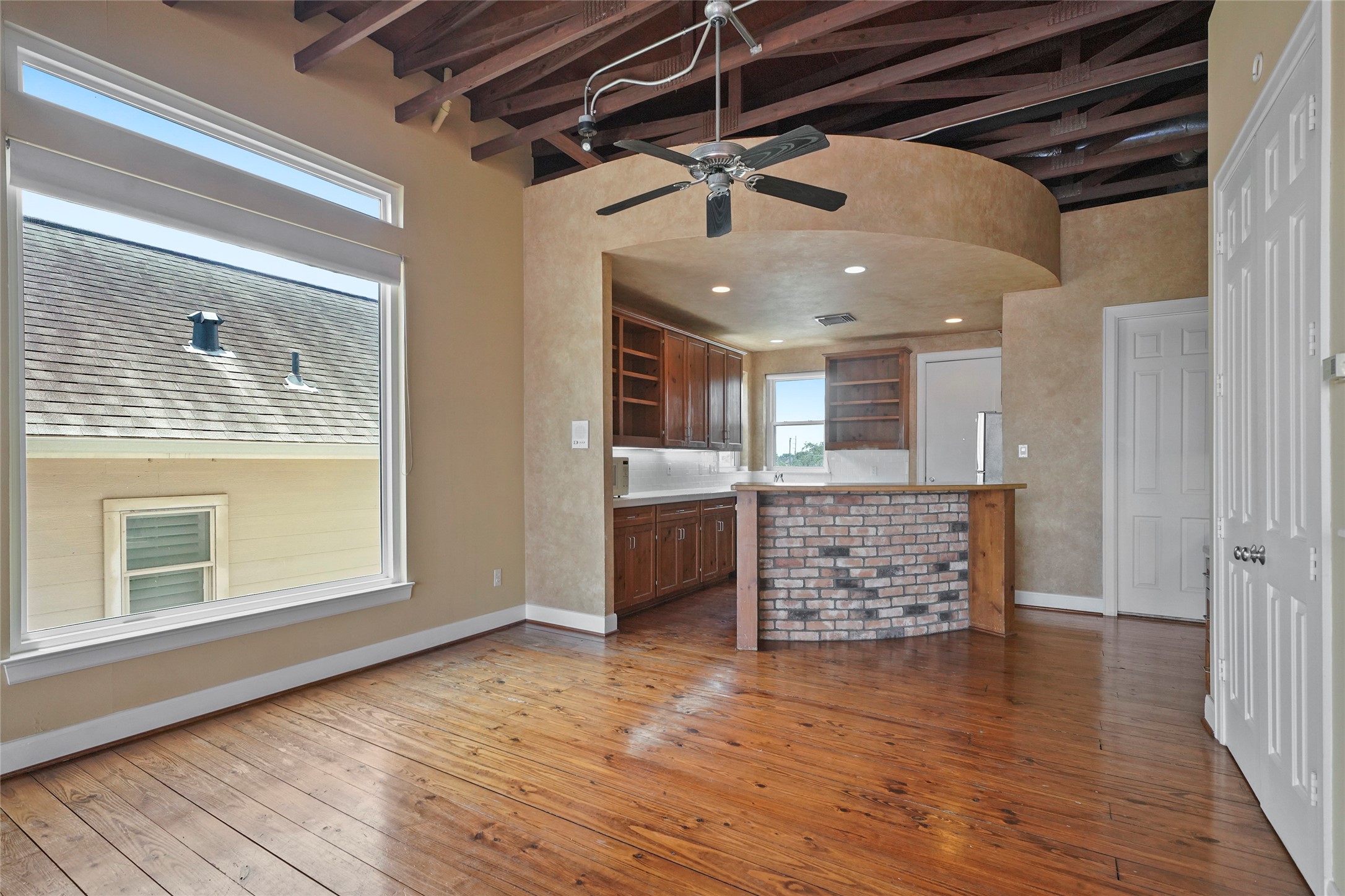 1514 Stanford Street Houston, TX 77019 - Photo 12 of 34 a view of an empty room with wooden floor and a window