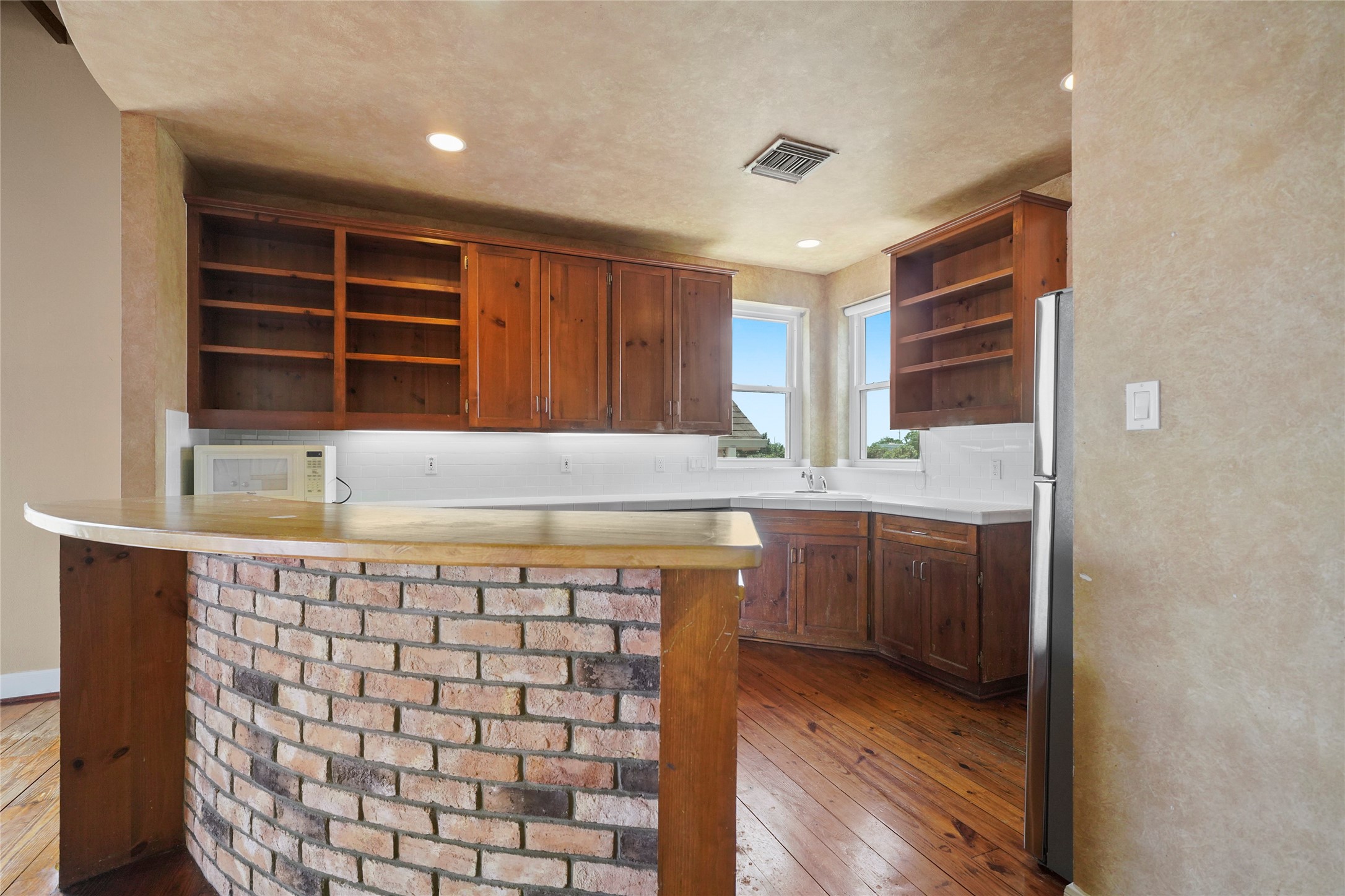1514 Stanford Street Houston, TX 77019 - Photo 14 of 34 a kitchen with a sink a window and cabinets
