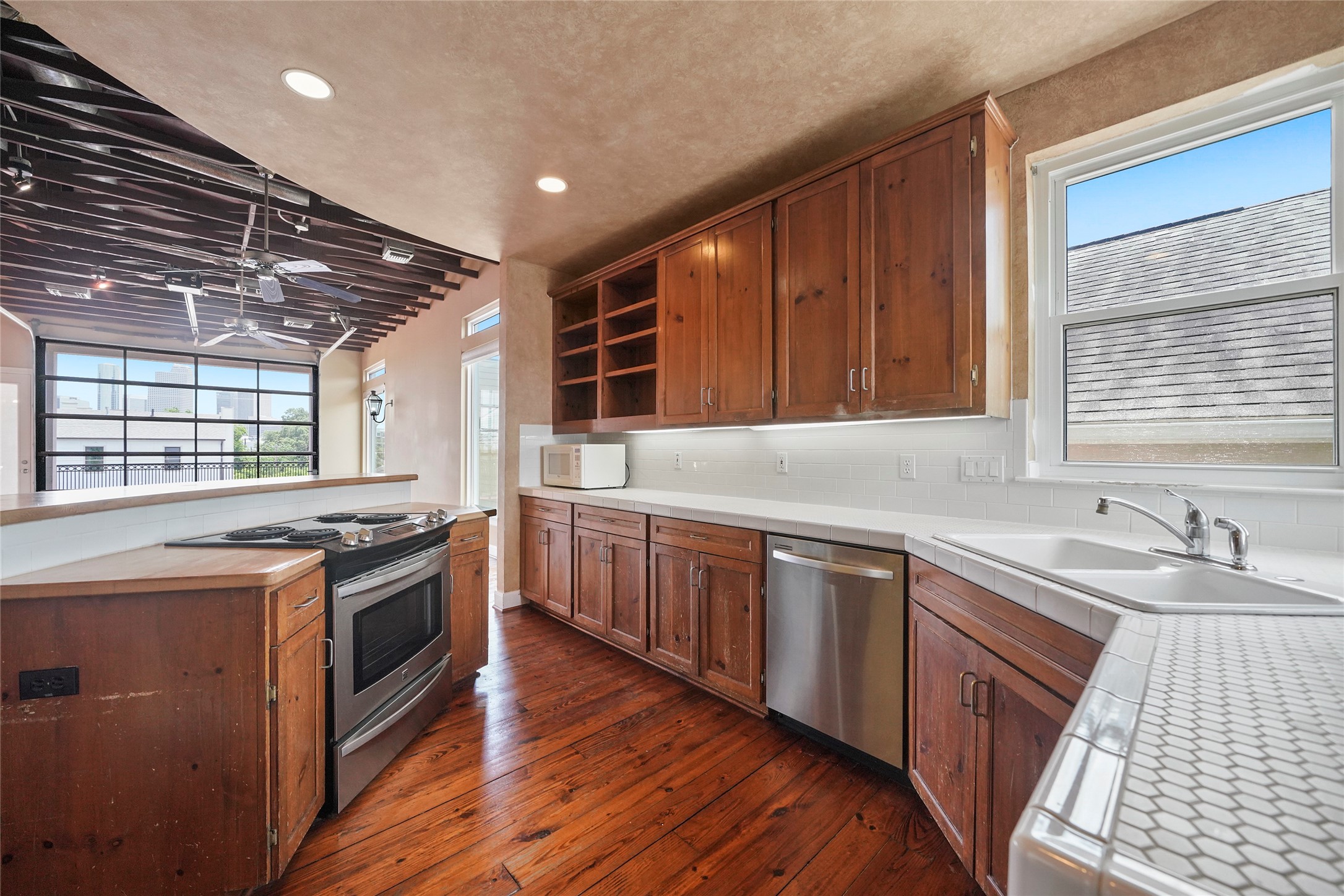 1514 Stanford Street Houston, TX 77019 - Photo 16 of 34 a kitchen with stainless steel appliances granite countertop a sink stove and wooden floor