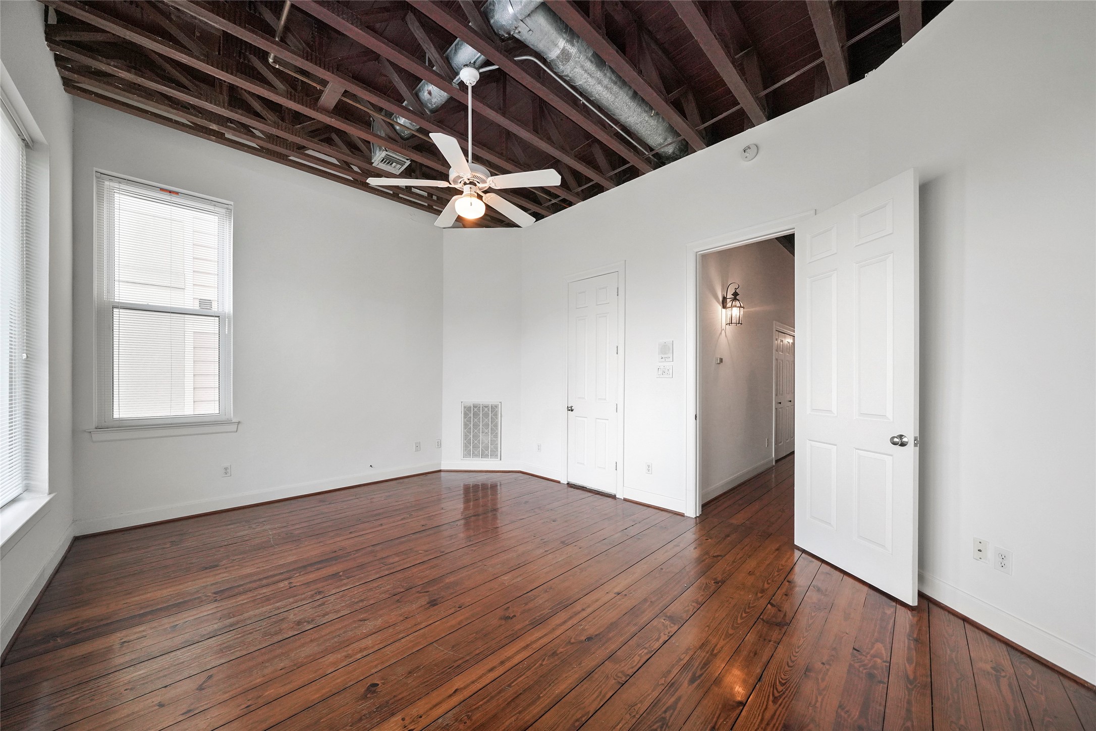 1514 Stanford Street Houston, TX 77019 - Photo 24 of 34 an empty room with wooden floor and windows