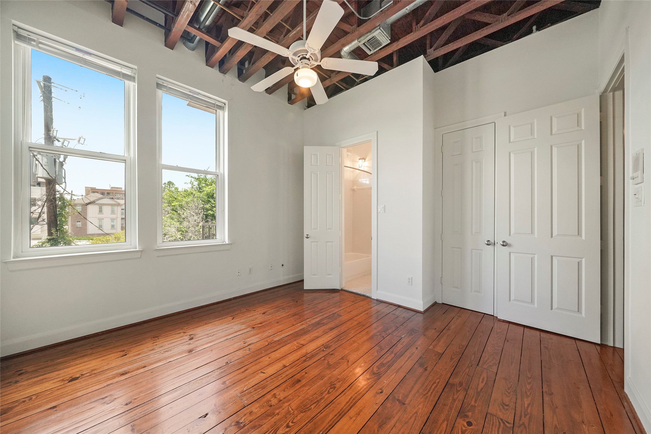 1514 Stanford Street Houston, TX 77019 - Photo 29 of 34 a view of an empty room with wooden floor and a window