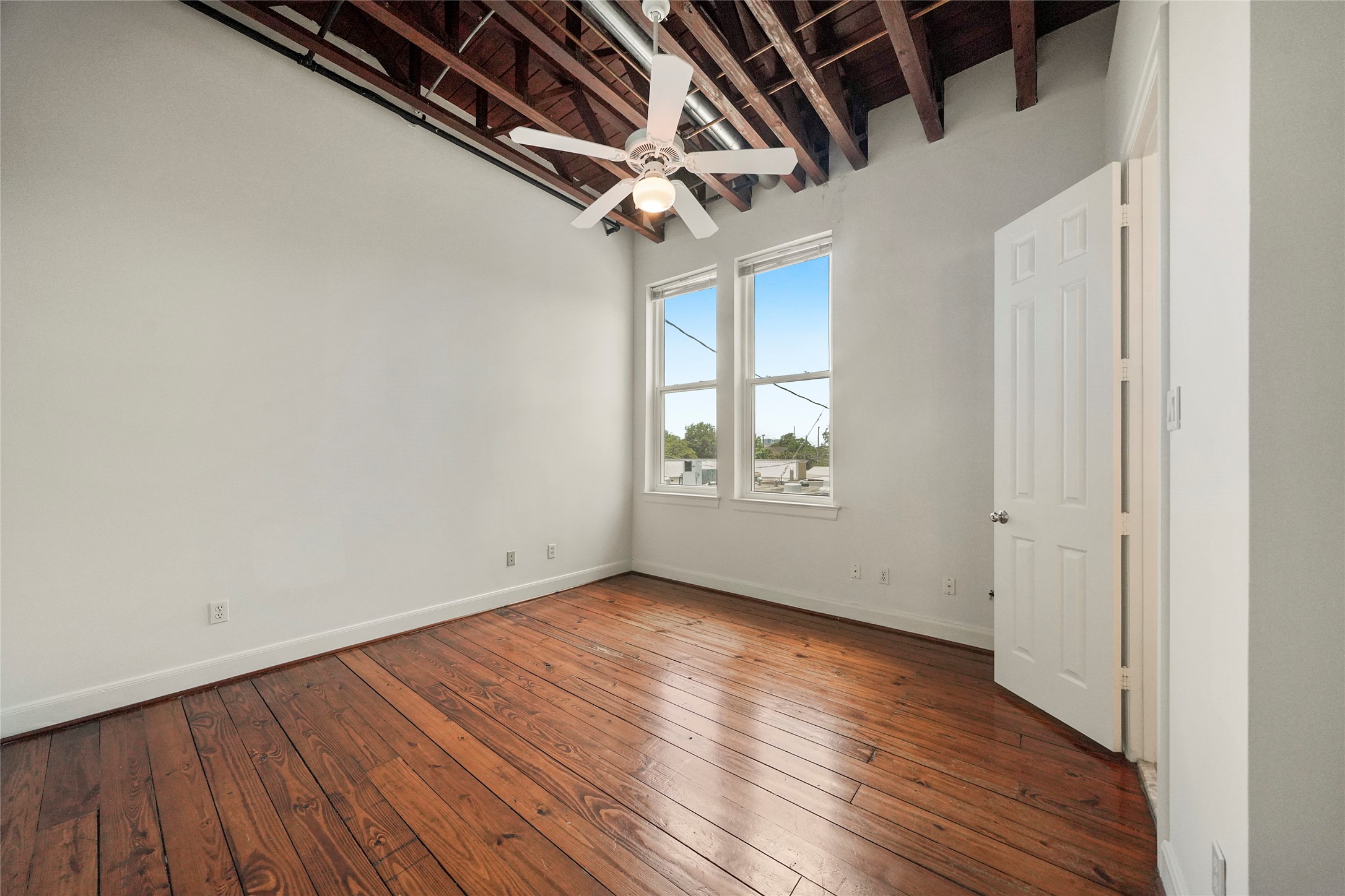1514 Stanford Street Houston, TX 77019 - Photo 30 of 34 an empty room with wooden floor and windows