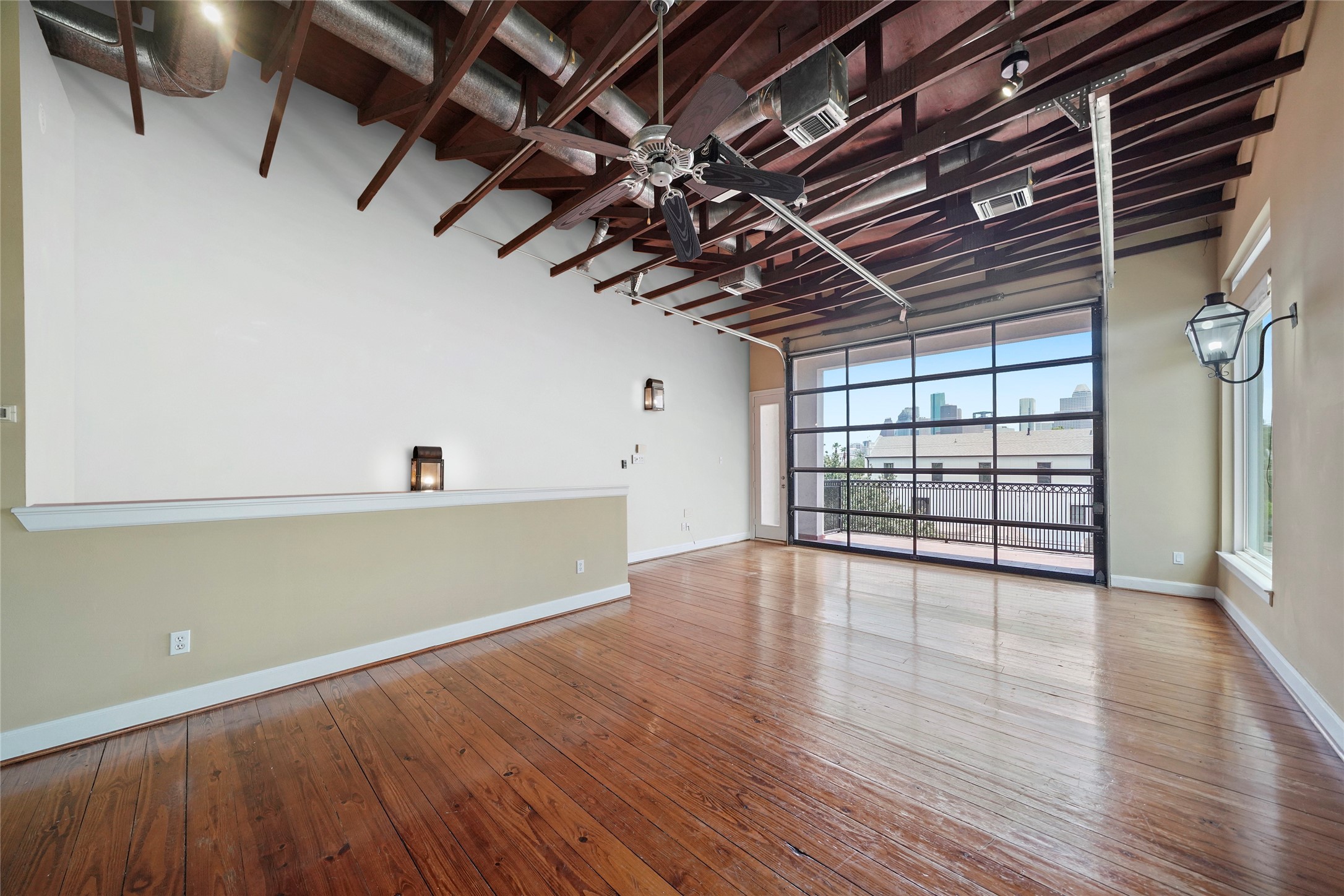1514 Stanford Street Houston, TX 77019 - Photo 7 of 34 a view of a room with wooden floors and a window