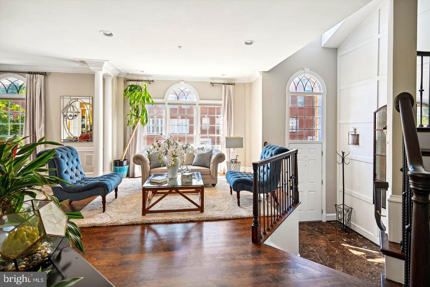 a living room with furniture and a floor to ceiling window