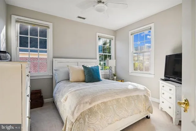 a bathroom with a sink mirror and toilet