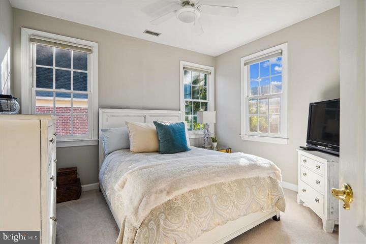 20366 Fallsway Terrace Sterling, VA 20165 - Photo 27 of 45 a bedroom with a bed flat screen tv and windows