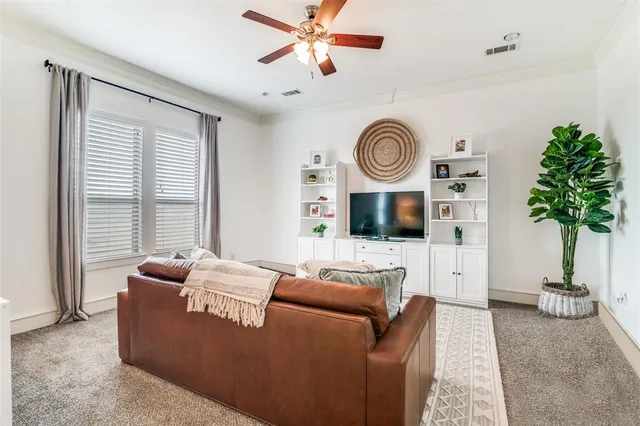 a living room with furniture a window and a flat screen tv