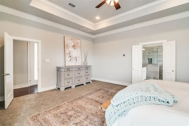 a spacious bedroom with a bed and a dresser