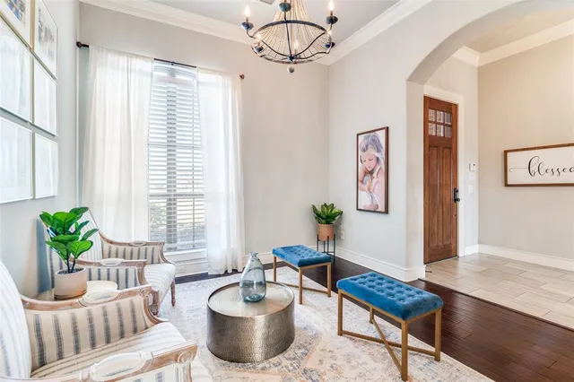 a living room with furniture and a potted plant