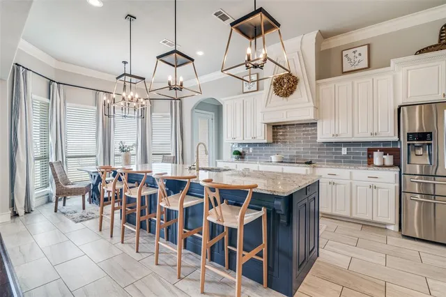 a large kitchen with a table and chairs