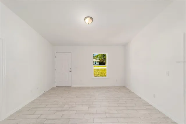 a view of a kitchen with wooden floor and windows