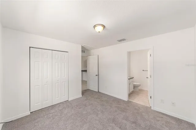 a bathroom with a granite countertop sink toilet a mirror and shower