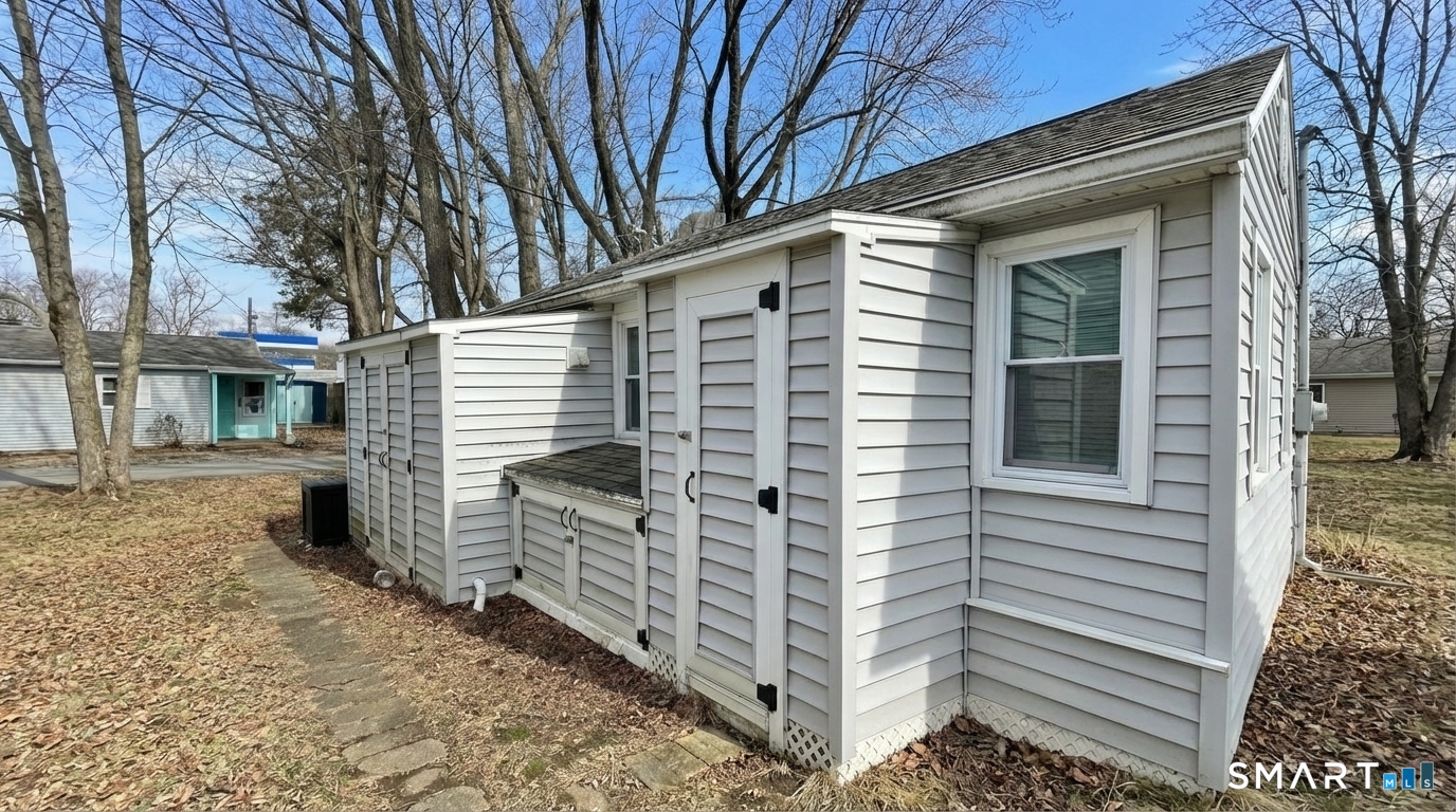 16 North Street Madison, CT 06443 - Photo 5 of 25 Back of cottage with 2 sheds and extra storage