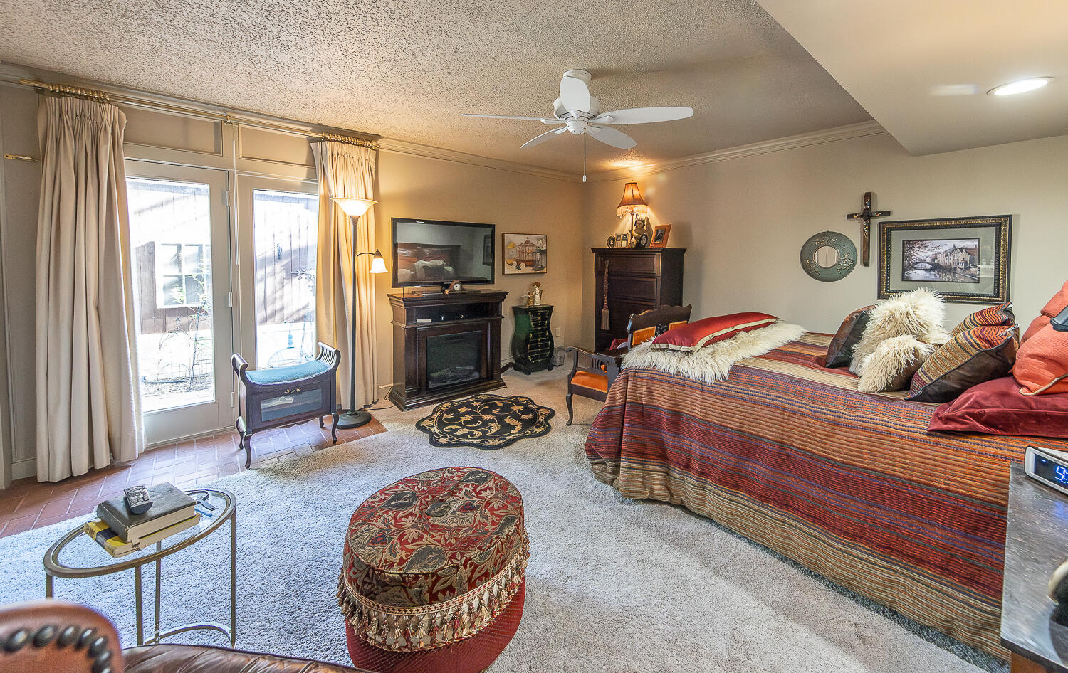 2302 Slide Road, Unit 25 Lubbock, TX 79407 - Photo 14 of 40 a bedroom with a bed and a chandelier