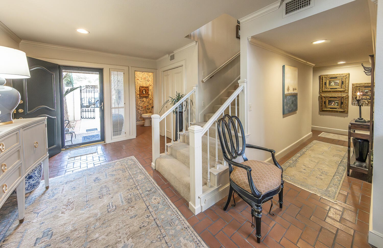2302 Slide Road, Unit 25 Lubbock, TX 79407 - Photo 18 of 40 a view of a livingroom with furniture a flat screen tv and staircase