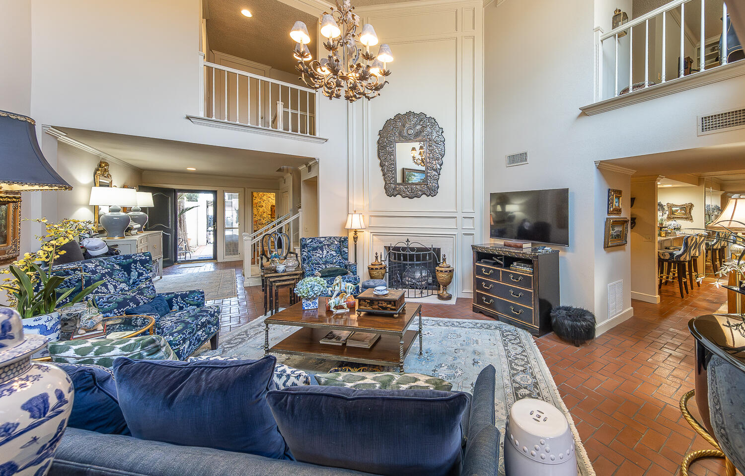 2302 Slide Road, Unit 25 Lubbock, TX 79407 - Photo 21 of 40 a living room with furniture a fireplace and a chandelier