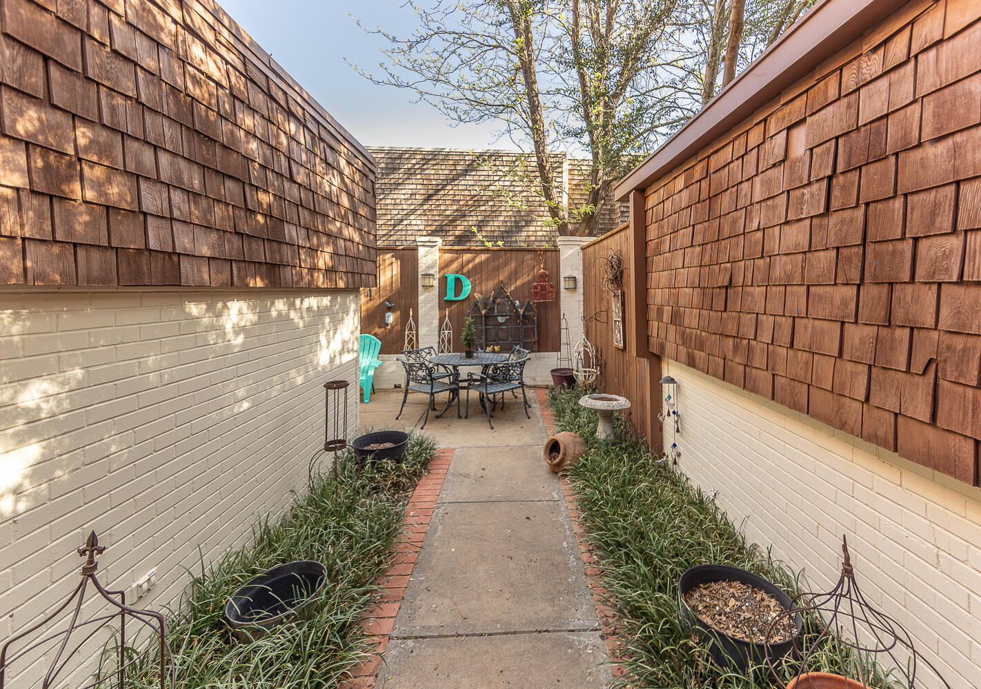 2302 Slide Road, Unit 25 Lubbock, TX 79407 - Photo 25 of 40 a view of a pathway with a bench in patio
