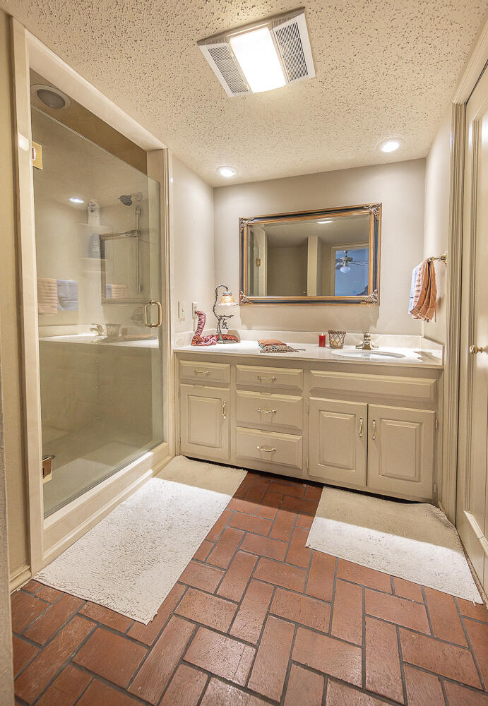 2302 Slide Road, Unit 25 Lubbock, TX 79407 - Photo 32 of 40 a room with a sink and a mirror