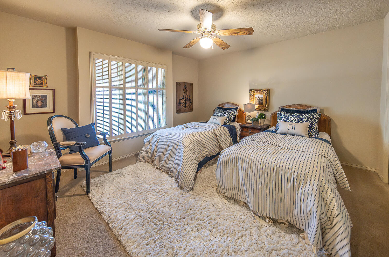 2302 Slide Road, Unit 25 Lubbock, TX 79407 - Photo 36 of 40 a bedroom with two beds and a chandelier