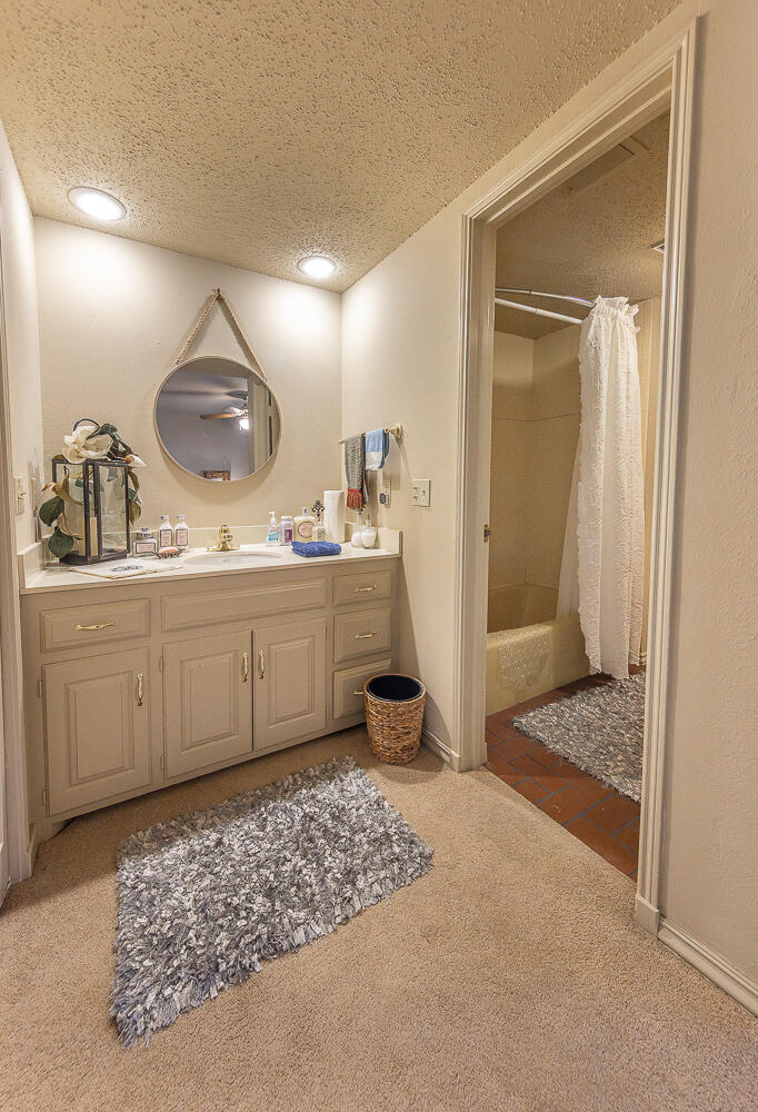 2302 Slide Road, Unit 25 Lubbock, TX 79407 - Photo 38 of 40 a room with a sink and a mirror