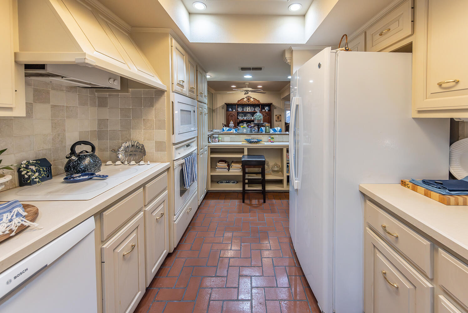 2302 Slide Road, Unit 25 Lubbock, TX 79407 - Photo 9 of 40 a kitchen with white cabinets and white appliances