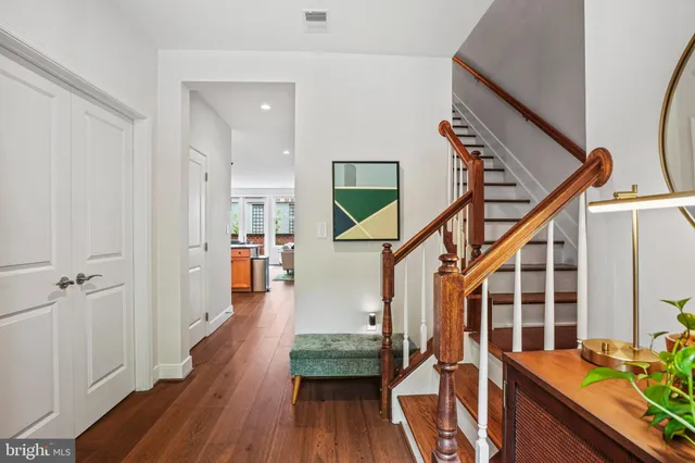 a view of entryway and hall with wooden floor