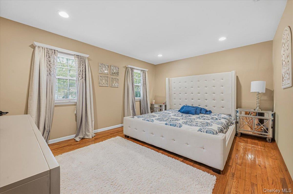 626 Caledonia Road Dix Hills, NY 11746 - Photo 23 of 49 a bedroom with a bed and wooden floor