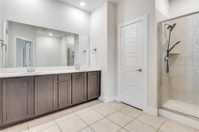 a bathroom with a double vanity sink and a mirror