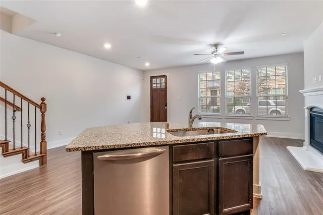a kitchen with center island cabinets and wooden floor