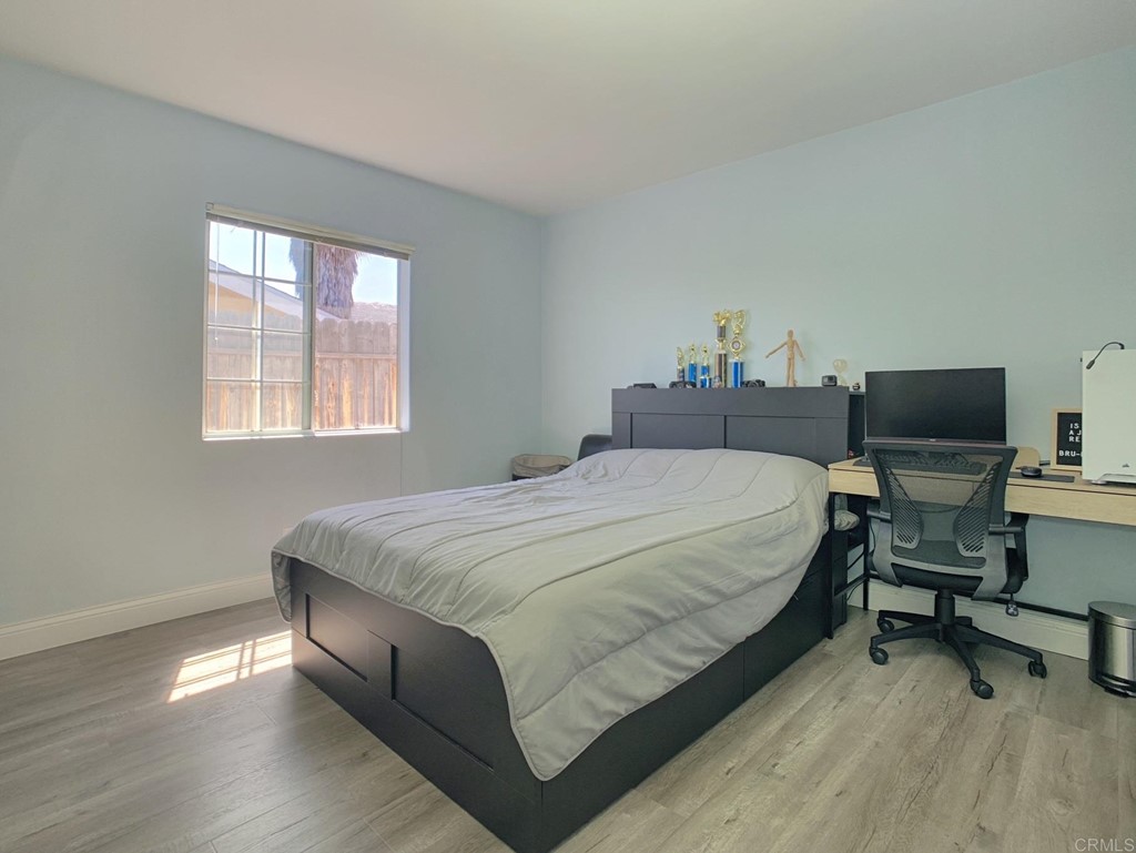 15935 Spring Oaks Road, Unit 63 El Cajon, CA 92021 - Photo 23 of 38 a bed sitting in a bedroom next to a window