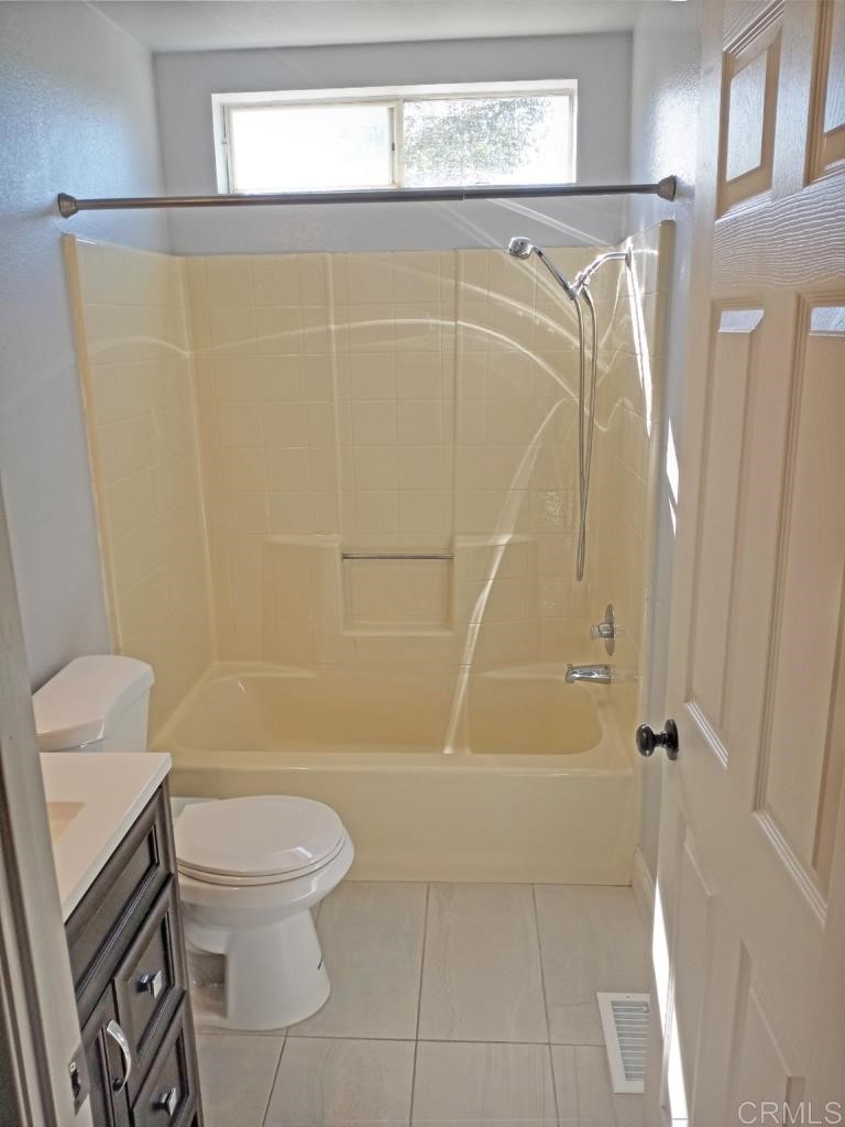 15935 Spring Oaks Road, Unit 63 El Cajon, CA 92021 - Photo 26 of 38 a bathroom with a shower a toilet and a shower