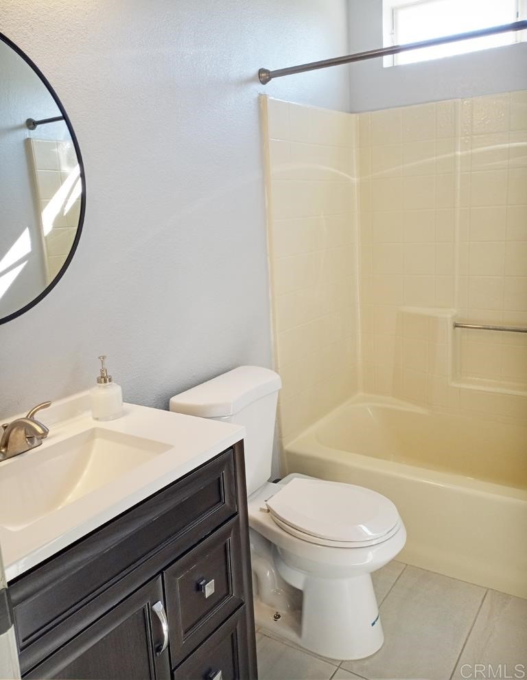 15935 Spring Oaks Road, Unit 63 El Cajon, CA 92021 - Photo 27 of 38 a bathroom with a sink a toilet and a mirror
