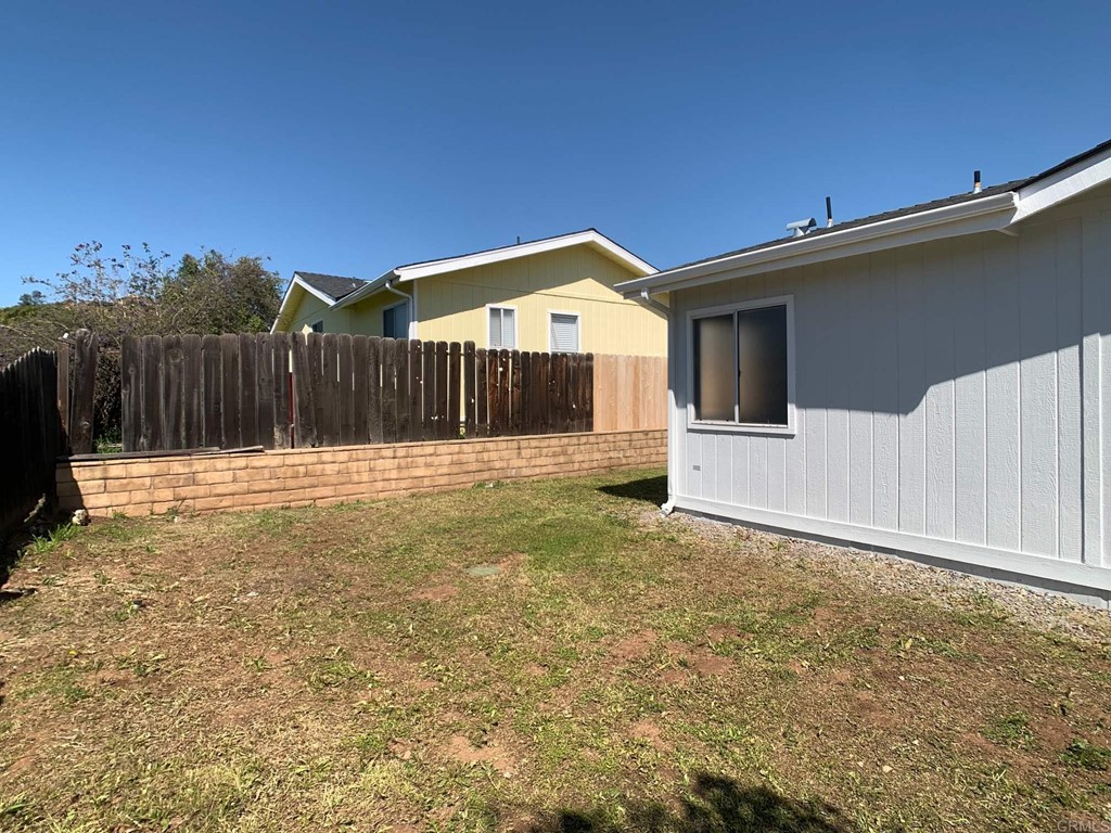 15935 Spring Oaks Road, Unit 63 El Cajon, CA 92021 - Photo 30 of 38 a backyard of a house