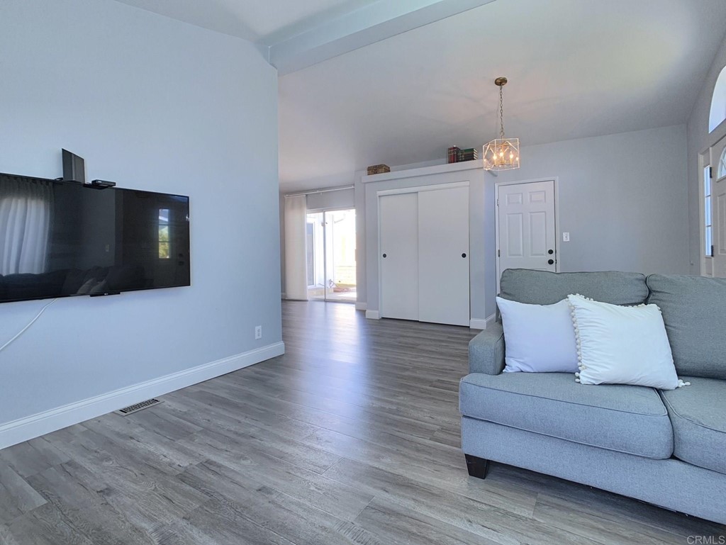 15935 Spring Oaks Road, Unit 63 El Cajon, CA 92021 - Photo 3 of 38 a living room with furniture and a flat screen tv