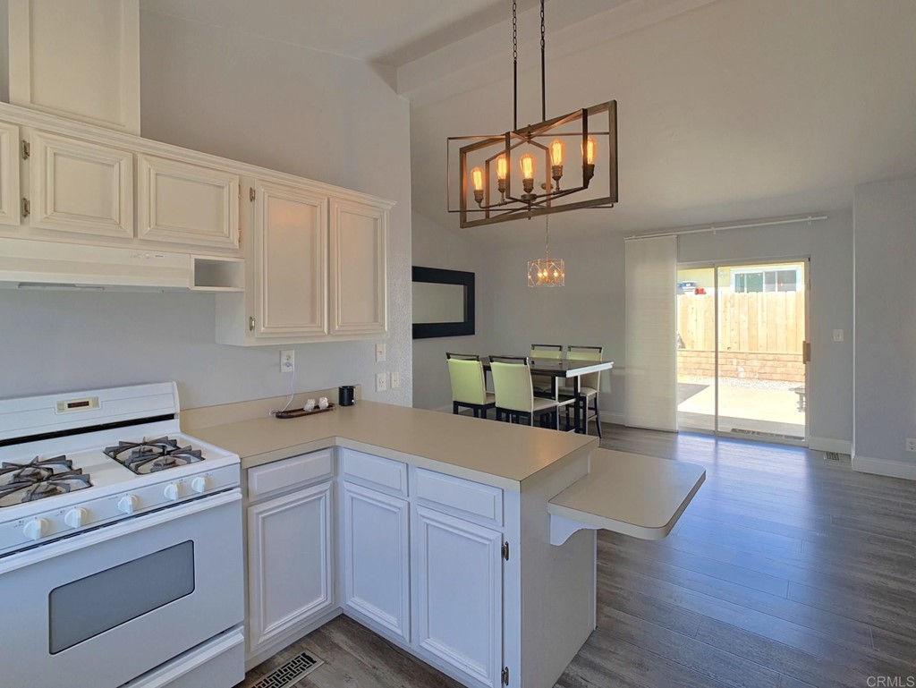15935 Spring Oaks Road, Unit 63 El Cajon, CA 92021 - Photo 6 of 38 a kitchen with a cabinets and wooden floor