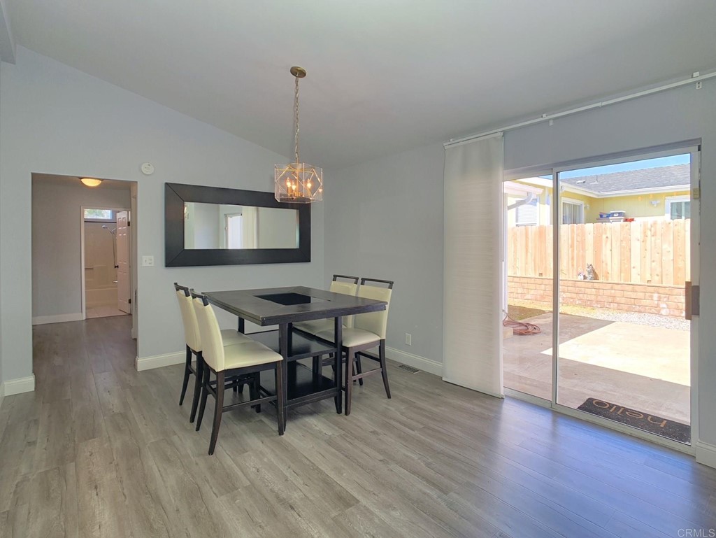 15935 Spring Oaks Road, Unit 63 El Cajon, CA 92021 - Photo 10 of 38 a view of a dining room with furniture window and wooden floor