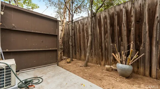 a large white kitchen with a stove a sink a dining table and chairs
