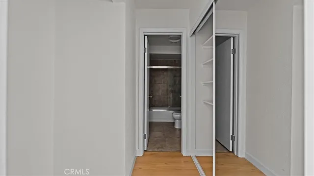 a bathroom with a granite countertop sink a toilet a mirror and shower